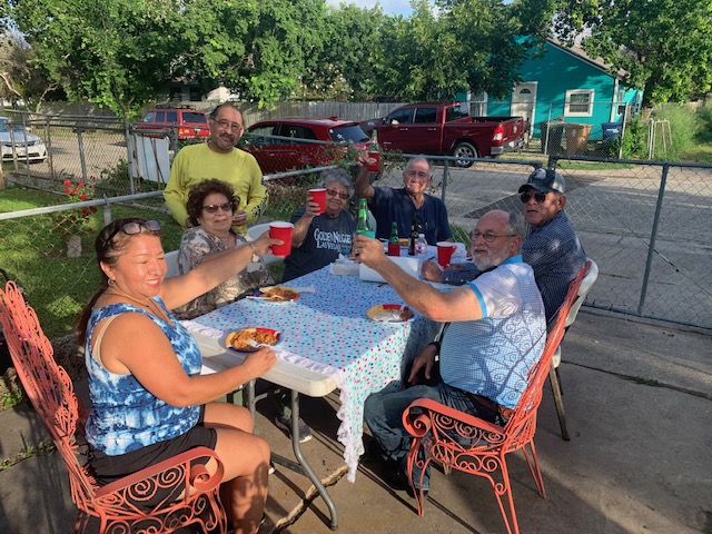 Neighbors meeting at a table outside in their neighborhood