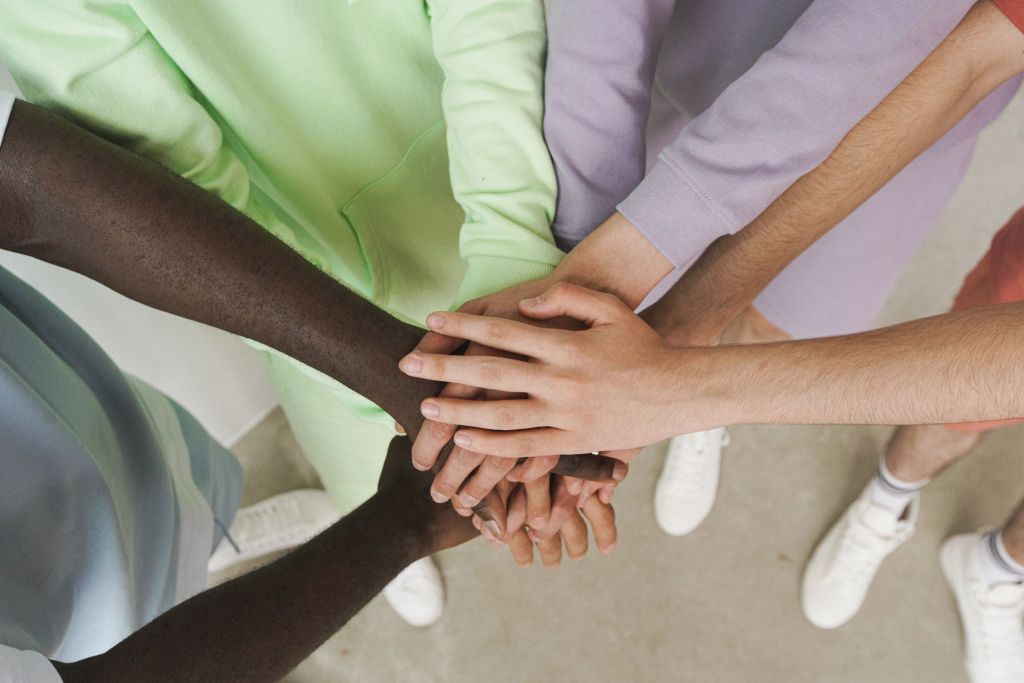 Racially diverse hands joined together in a circle